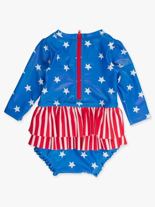 RUFFLEBUTTS SHIMMER STARS & STRIPES LONG SLEEVE SKIRTED RASH GUARD