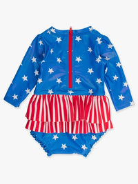 RUFFLEBUTTS SHIMMER STARS & STRIPES LONG SLEEVE SKIRTED RASH GUARD