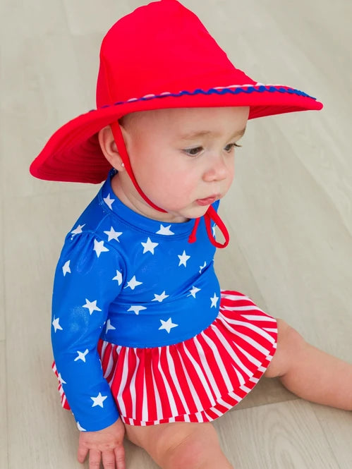 RUFFLEBUTTS SHIMMER STARS & STRIPES LONG SLEEVE SKIRTED RASH GUARD