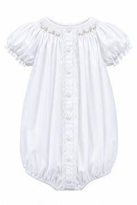 A baby bodysuit with short puff sleeves, lace trim, and a button-down front, hanging on a white hanger against a light gray background.