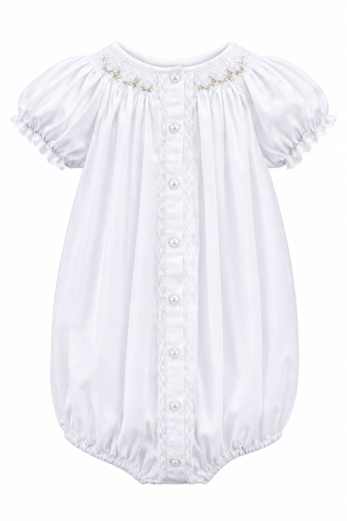 A baby bodysuit with short puff sleeves, lace trim, and a button-down front, hanging on a white hanger against a light gray background.