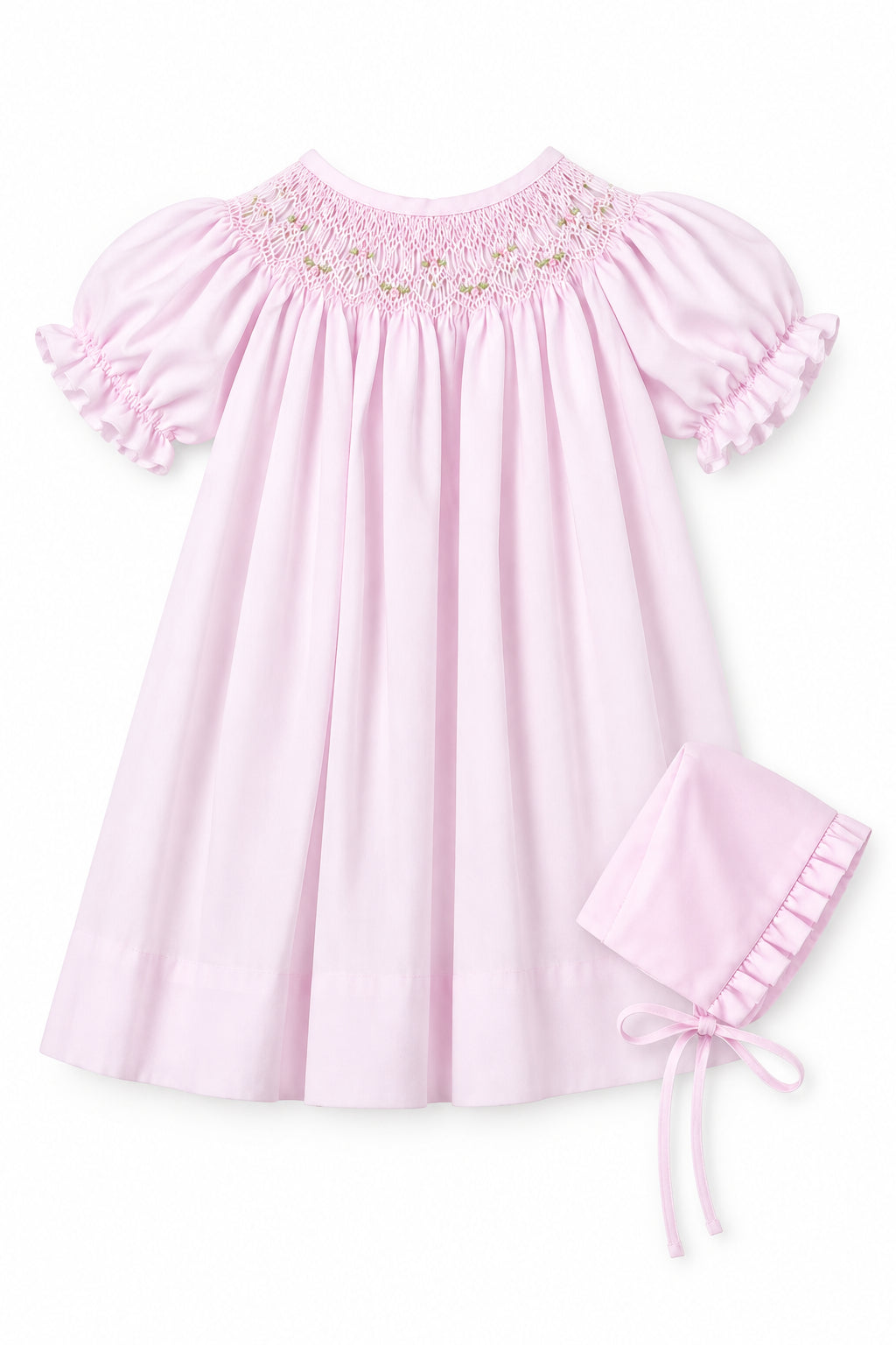A light pink baby smocked dress with short ruffled sleeves and a matching bonnet, shown on a hanger against a neutral gray background with an inset image of the bonnet.