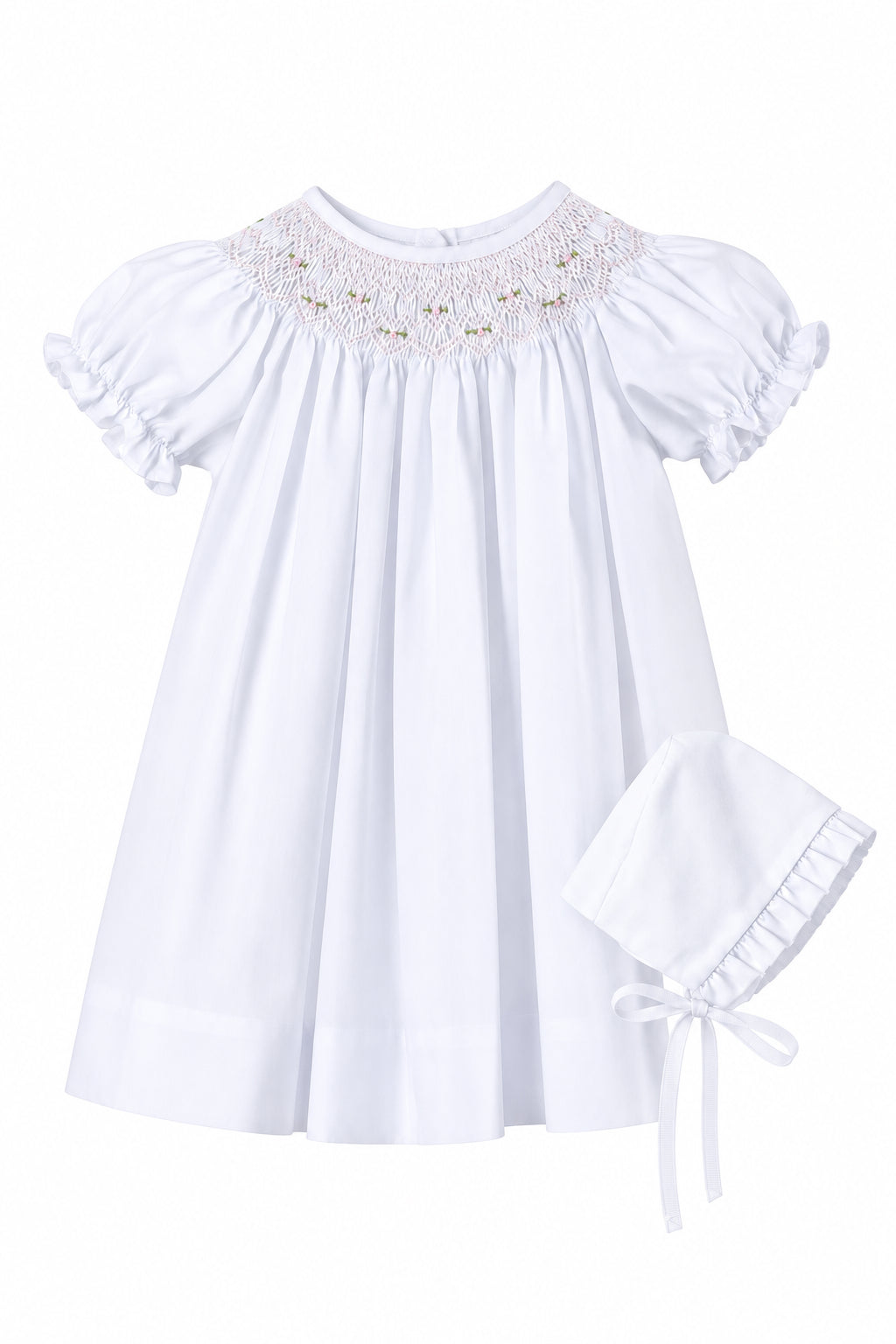 White baby dress with lace details on a gray background, accompanied by a matching bonnet.