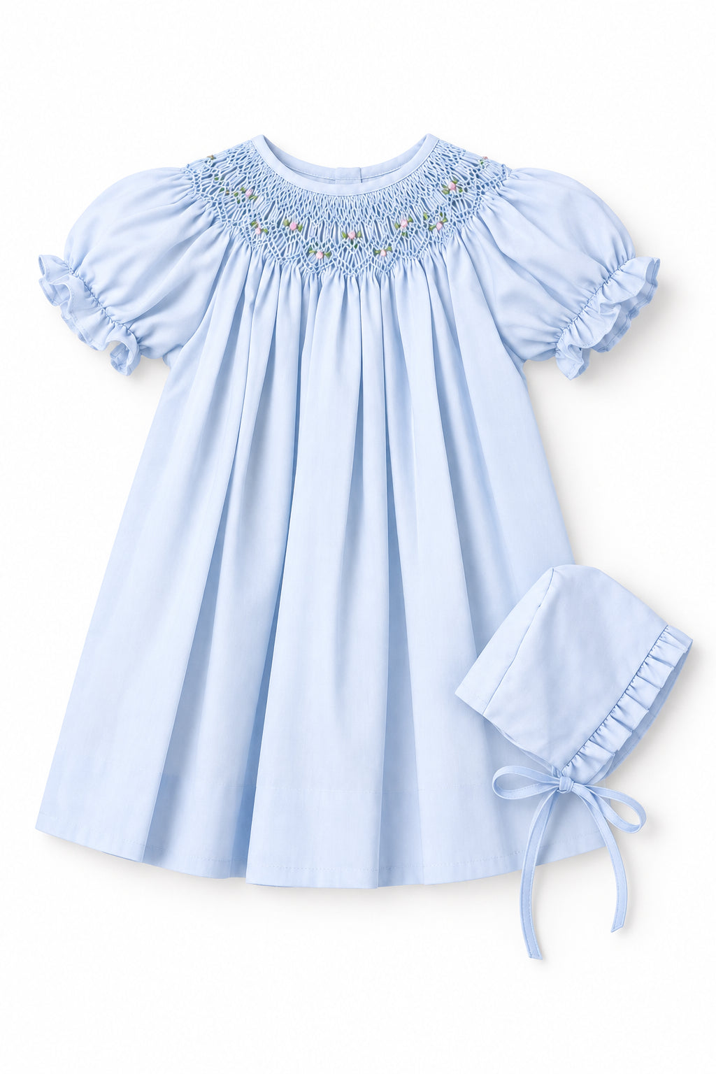 A light blue baby girl's dress with short puff sleeves and a smocked yoke, shown on a hanger with an inset image of a matching bonnet.
