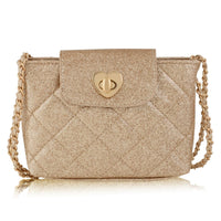 A small quilted shoulder bag in a textured champagne gold finish, featuring a gold heart-shaped clasp on the front flap and a gold chain strap, set against a plain white background.