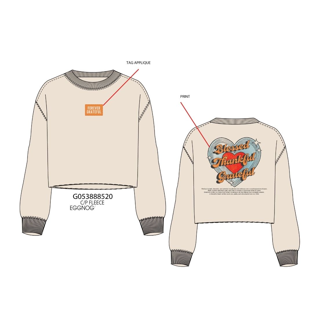 Front and back views of a cropped long-sleeve sweatshirt in a warm off-white/cream color. The front has a small orange rectangular tag graphic on the left chest, and the back has a large graphic featuring a gray heart with red and orange text reading 'Blessed Thankful Grateful.
