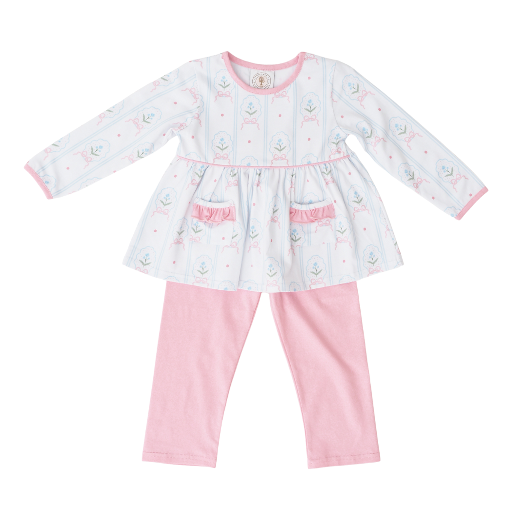 Baby girl's outfit with a white dress and pink pants on a white background