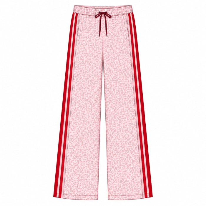A flat technical drawing of wide-leg pants on a white background, labeled with style code H085890211 and material text reading 'GARDENIA COTTON POLY FLEECE.' The pants are light pink with a dense small floral print and bold red side stripes, plus a dark red drawstring at the waist.