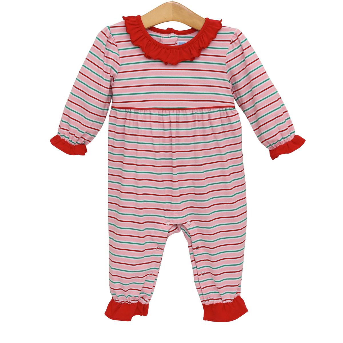 A baby long-sleeve footless jumpsuit with horizontal pink, red, and light blue stripes, featuring a red ruffled collar, red cuffs, and red cuffed ankles, hanging on a wooden hanger against a white background.