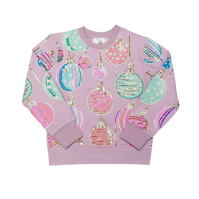 A lavender crewneck sweatshirt featuring an all-over print of sequined Christmas ornaments in pink, mint green, and blue, displayed flat against a white background.