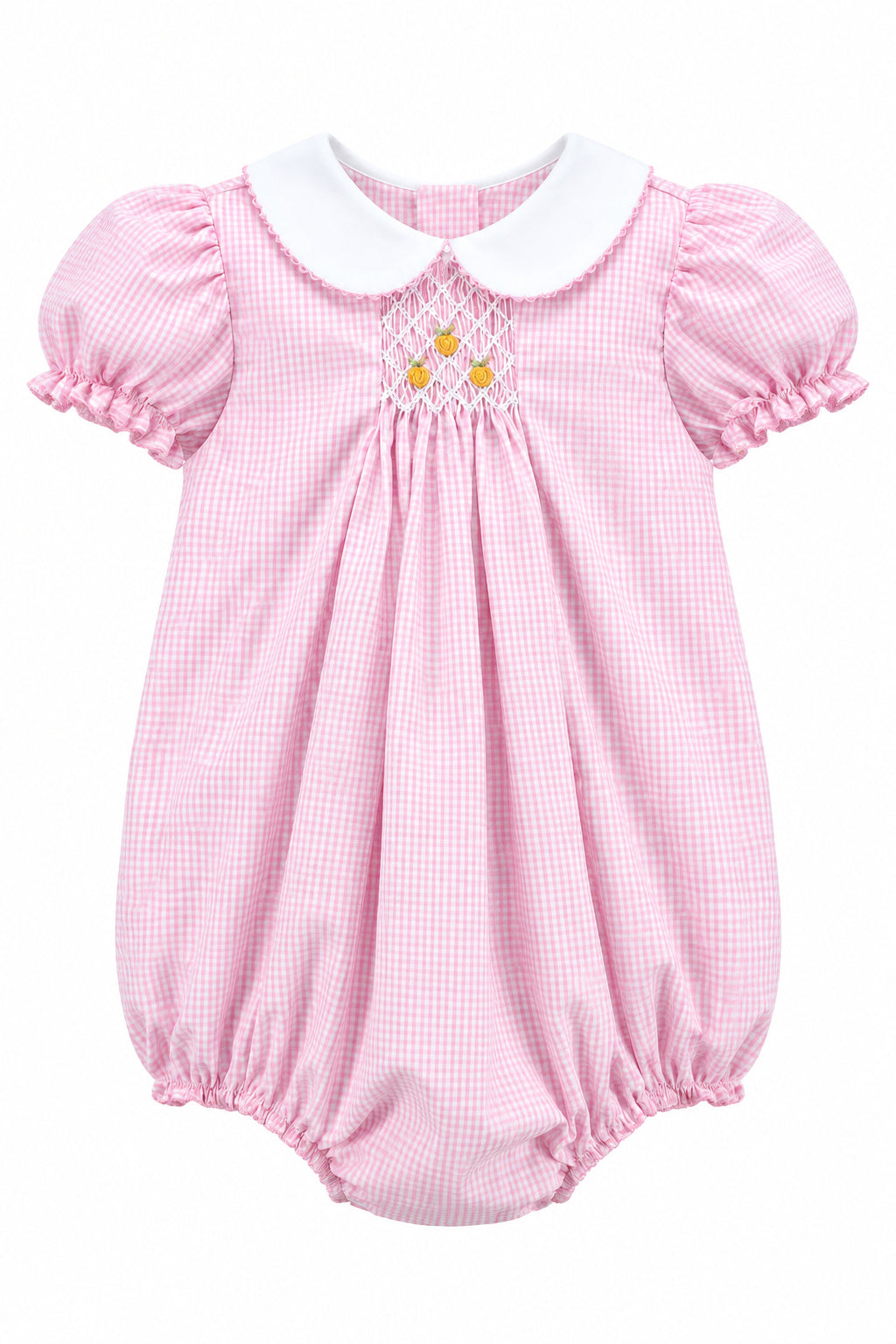 A pink and white gingham baby romper with a white Peter Pan collar, short ruffled sleeves, and a smocked chest detail with three yellow buttons, shown on a hanger against a solid gray background.