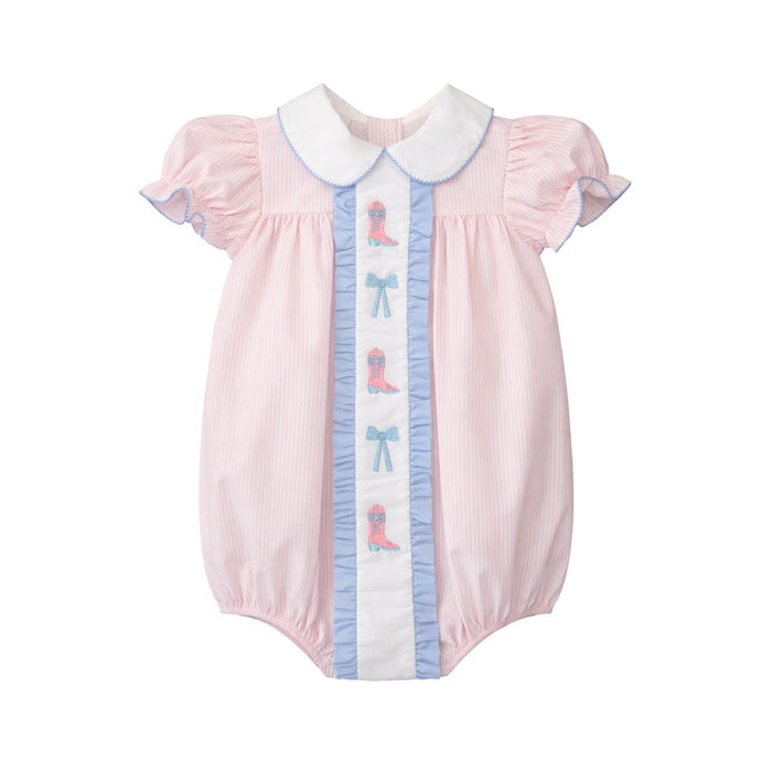 A baby girl's short-sleeve bubble romper in light pink and white pinstripes, featuring a white Peter Pan collar, a white center panel with blue ruffles, blue bows, and pink cowboy boot motifs, and light blue piping on the ruffled sleeves.