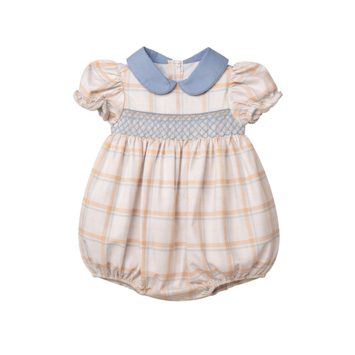 A baby girl's short-sleeve smocked romper in a beige and orange plaid pattern with a light blue Peter Pan collar and smocked trim.