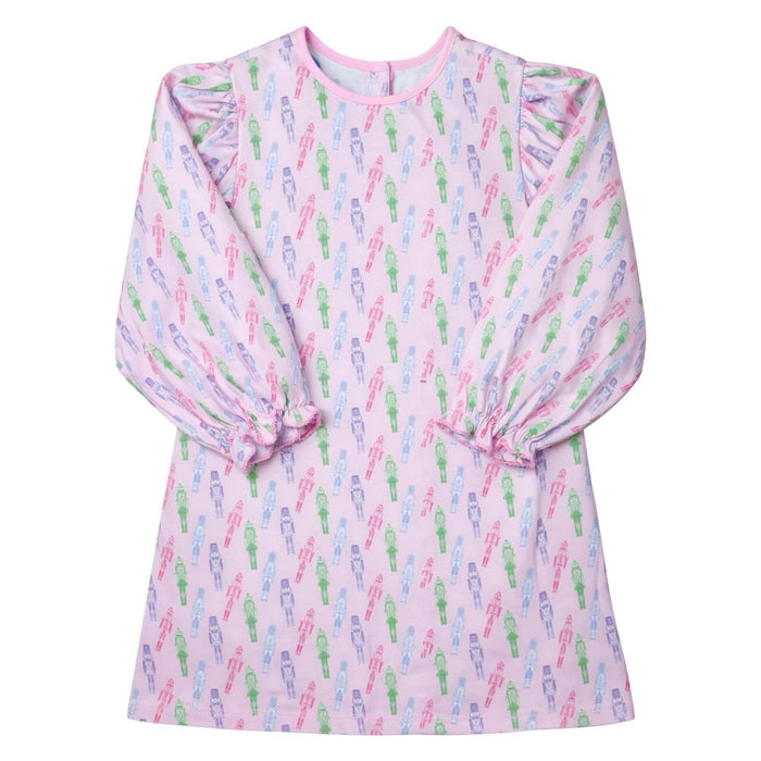 A light pink long-sleeve dress with an allover pattern of colorful cactus silhouettes in green, blue, and purple, featuring ruffled shoulders and gathered cuffs.
