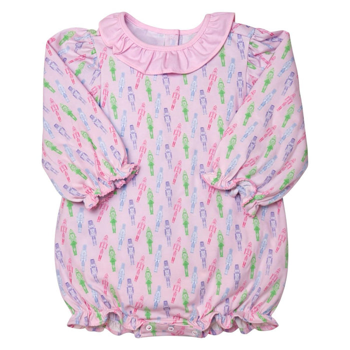 A pink long-sleeve baby romper with an all-over colorful printed pattern of stick-figure-like characters, featuring a ruffled collar and elasticized cuffs and hem.