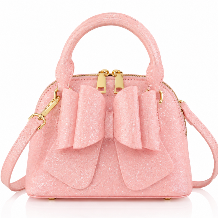 Pink handbag with gold accents and a bow on a white background