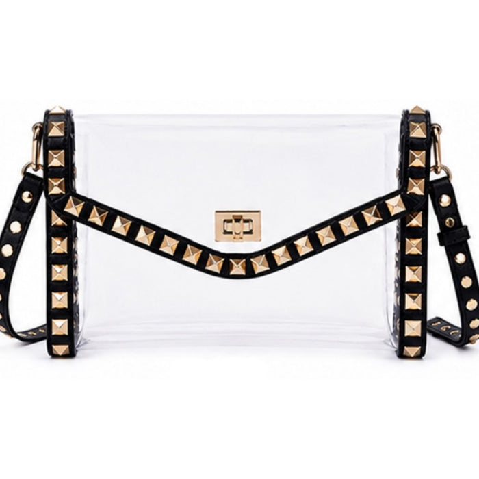 A clear plastic crossbody bag with a black studded strap and gold-tone hardware, shown against a plain white background.