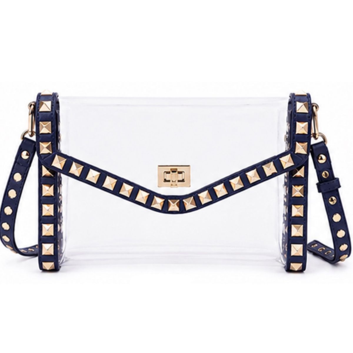 A clear plastic clutch bag with navy blue faux-leather trim and gold pyramid studs, featuring a gold-tone metal logo plate on the front.