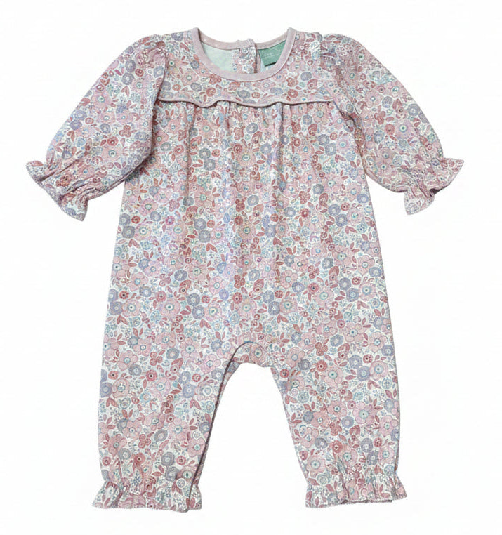 A baby girl's long-sleeve romper with a dense floral pattern in dusty pink, blue, and green, featuring a ruffled collar and elasticated leg cuffs, shown flat on a white background.