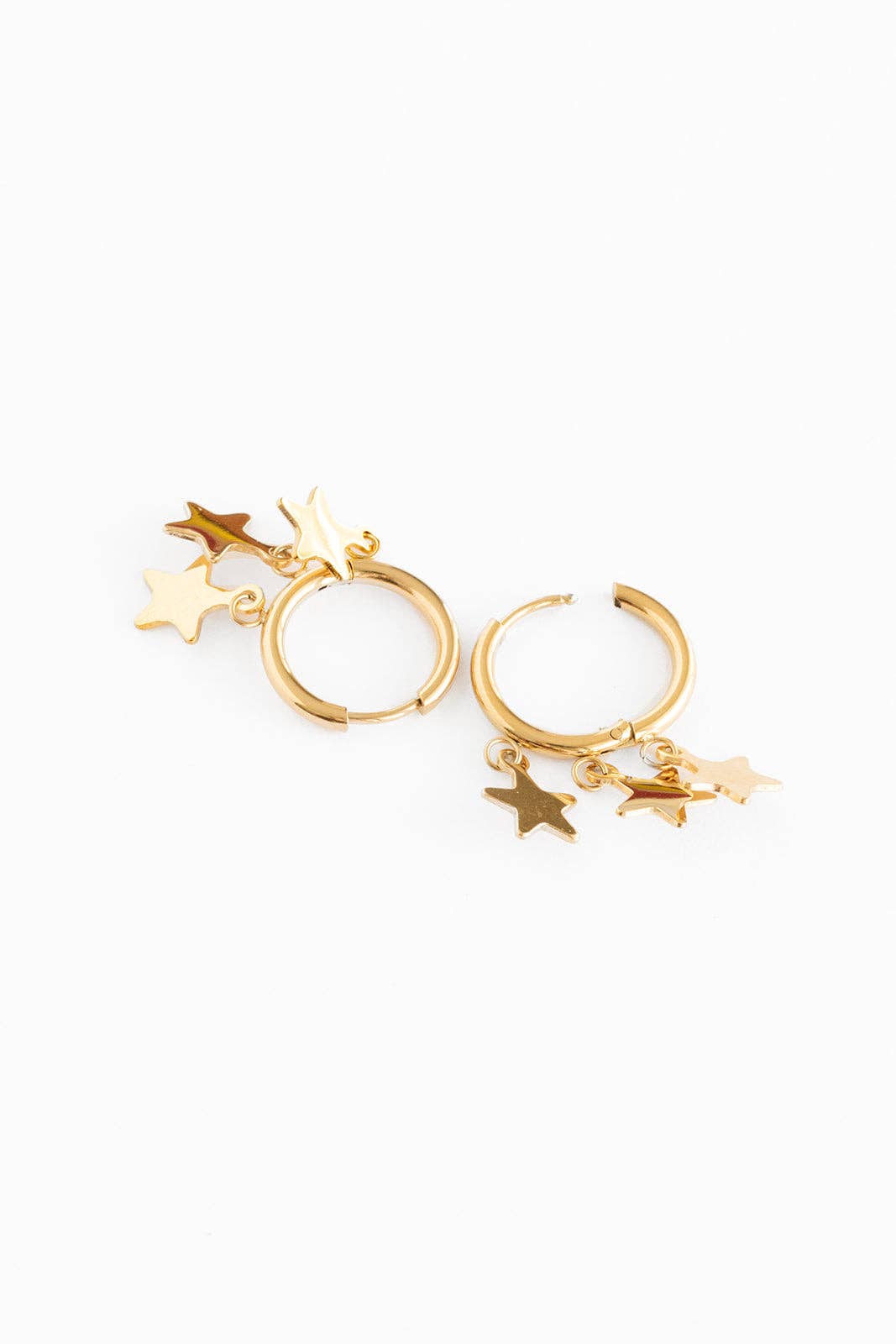 Gold hoop earrings with star charms on a white background