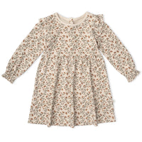 A long-sleeve baby dress with a beige and brown floral pattern, featuring ruffled sleeves and a gathered waist, laid flat on a white background.