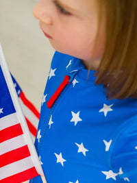 RUFFLEBUTTS SHIMMER STARS & STRIPES GIRLS SHORT SLEEVE ONE PIECE RASH GUARD