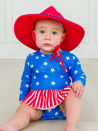 RUFFLEBUTTS SHIMMER STARS & STRIPES LONG SLEEVE SKIRTED RASH GUARD