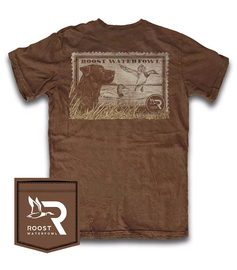 A brown short-sleeve t-shirt shown from the back, featuring a large vintage-style graphic print with a dog, ducks, and the text 'BOOST WATERFOWL'. A matching brown patch with the 'Roost Waterfowl' logo is displayed in the bottom-left corner against a white background.