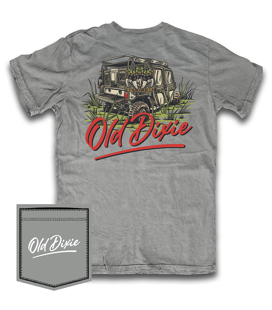 A heather gray short-sleeve t-shirt featuring a back graphic of a vintage off-road vehicle with the text 'Old Dixie' in red script. A matching gray fabric pocket graphic with the 'Old Dixie' logo is shown in the bottom-left corner on a white background.
