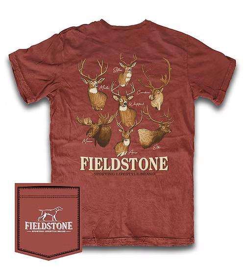 A rust-red short-sleeve t-shirt with a graphic print of various deer and moose heads on the back, featuring the text 'FIELDSTONE SPORTING LIFESTYLE BRAND'. A matching fabric pocket is shown in the bottom-left corner with the Fieldstone logo.
