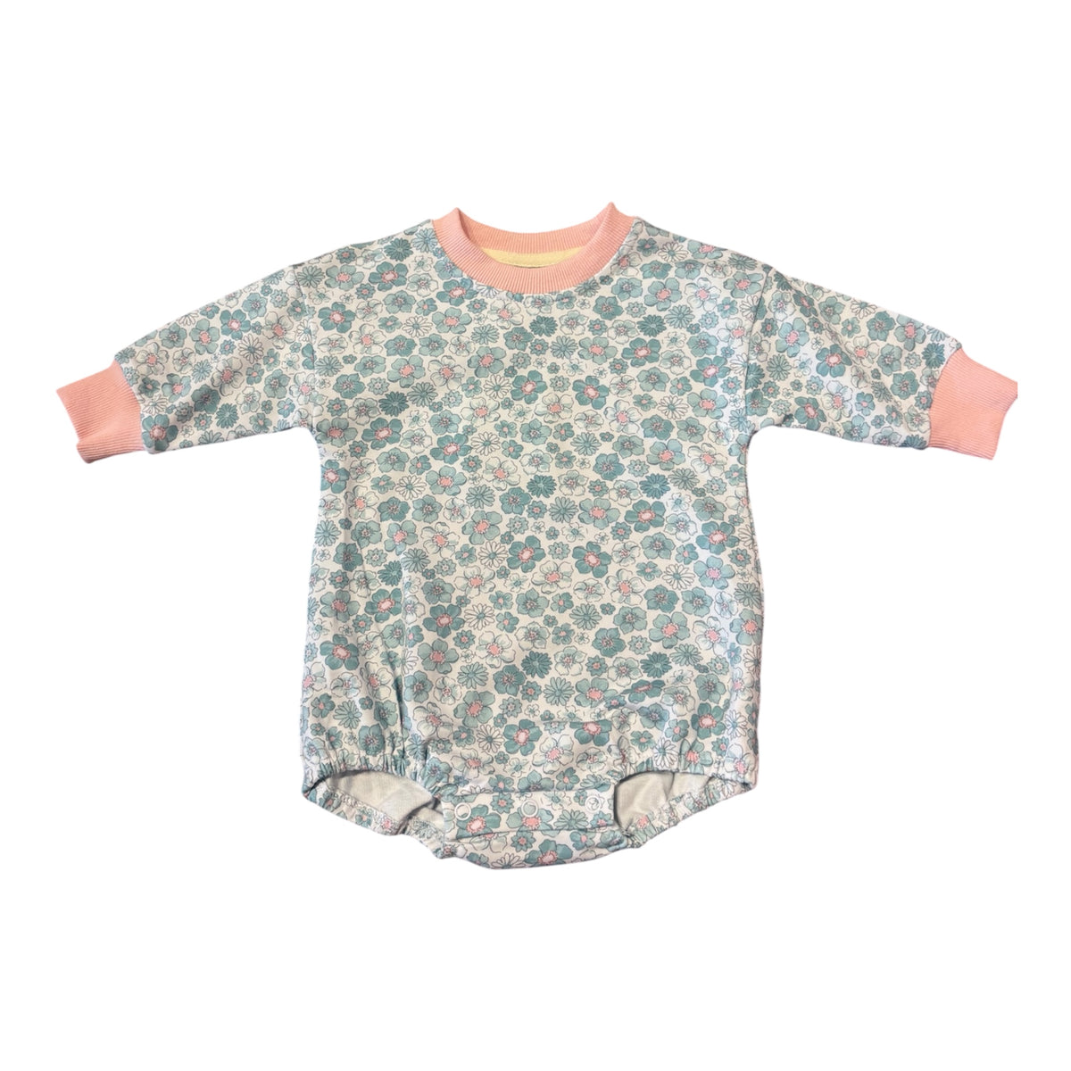 A baby long-sleeve romper with a dense floral print in teal, pink, and cream, featuring solid peach-pink ribbed collar and cuffs, laid flat on a white background.