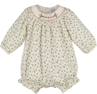 A baby long-sleeve romper in cream cotton fabric with a small green and red floral print, featuring a smocked neckline with red trim and green floral embroidery.