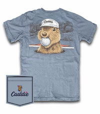 A light blue-gray short-sleeve t-shirt featuring a graphic of a brown groundhog wearing a white 'Caddie' cap and holding a golf ball. A matching 'Caddie' branded pocket graphic is shown in the bottom-left corner against a white background.