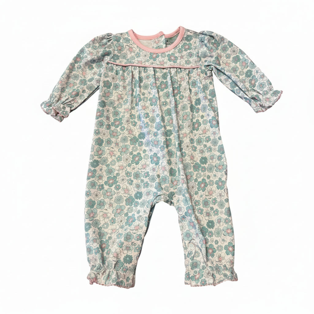 A baby long-sleeve floral romper in a muted teal and pink pattern on a cream background, featuring a pink collar and smocked chest detail, laid flat on a white background.