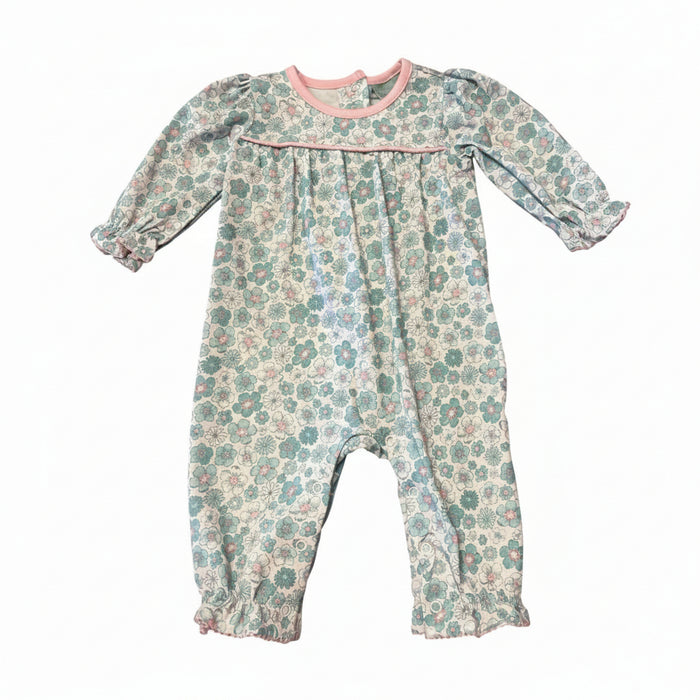 A baby long-sleeve floral romper in a muted teal and pink pattern on a cream background, featuring a pink collar and smocked chest detail, laid flat on a white background.