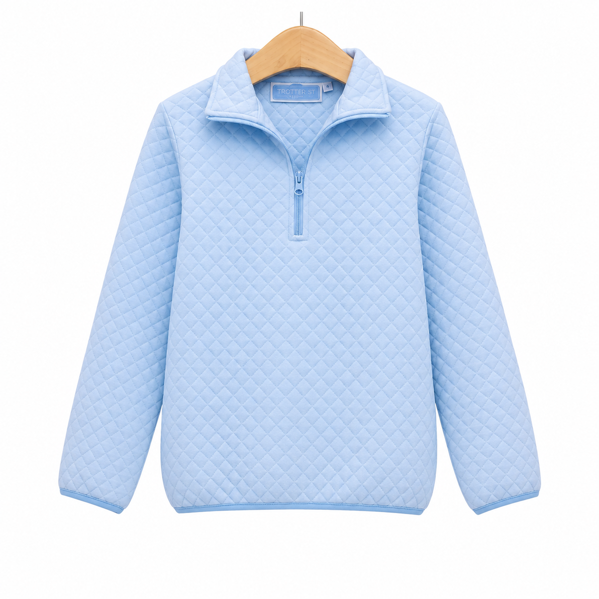 A light blue quilted quarter-zip pullover sweater hanging on a wooden hanger against a plain white background.