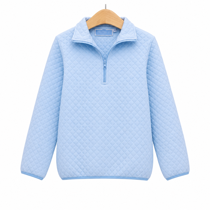 A light blue quilted quarter-zip pullover sweater hanging on a wooden hanger against a plain white background.