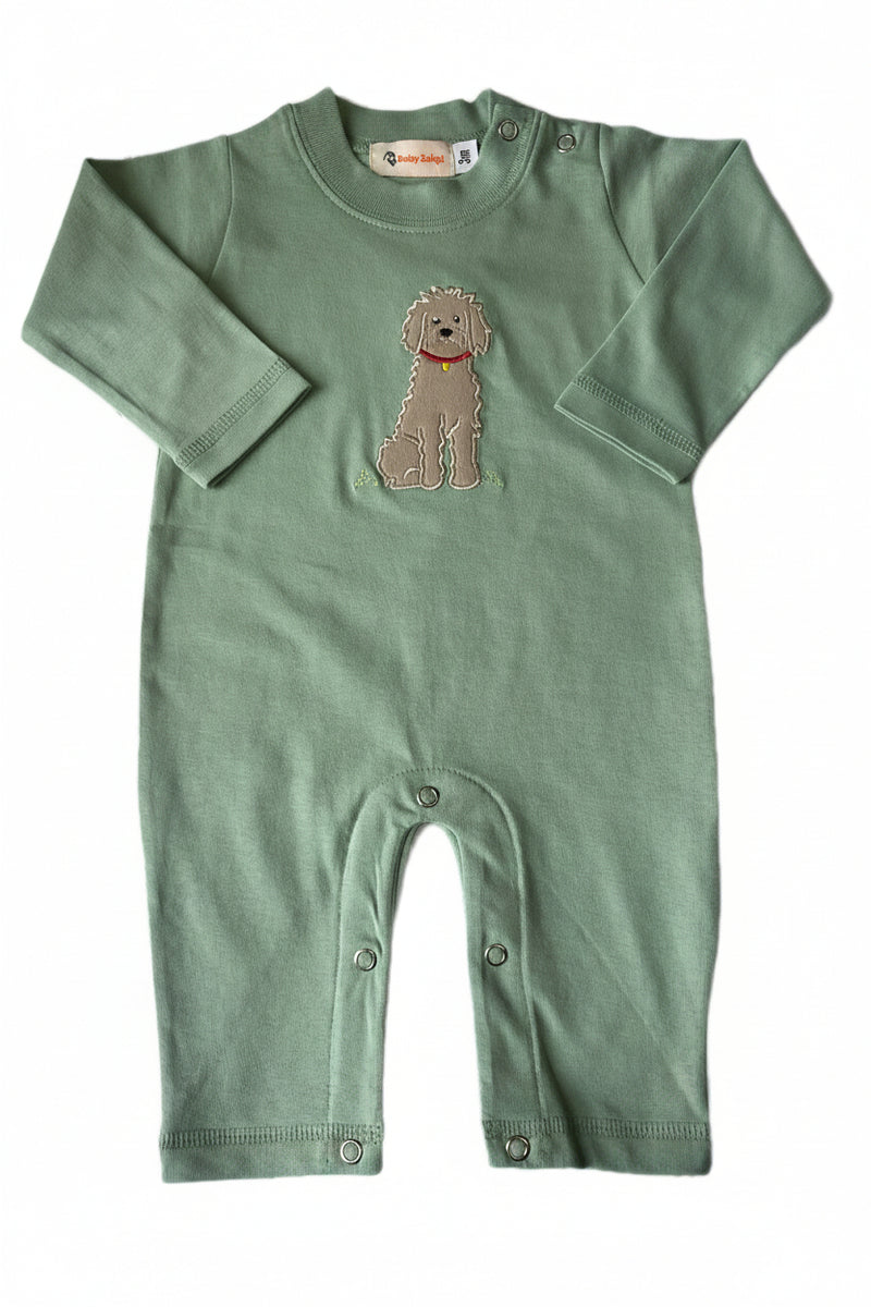 Green baby romper with embroidered dog design on a white background