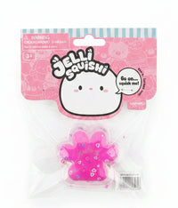 A Jellibaboy Jelliquisquish toy in its original packaging, featuring a translucent pink paw-shaped squishy on a clear plastic blister pack with a pink and white cardboard header.