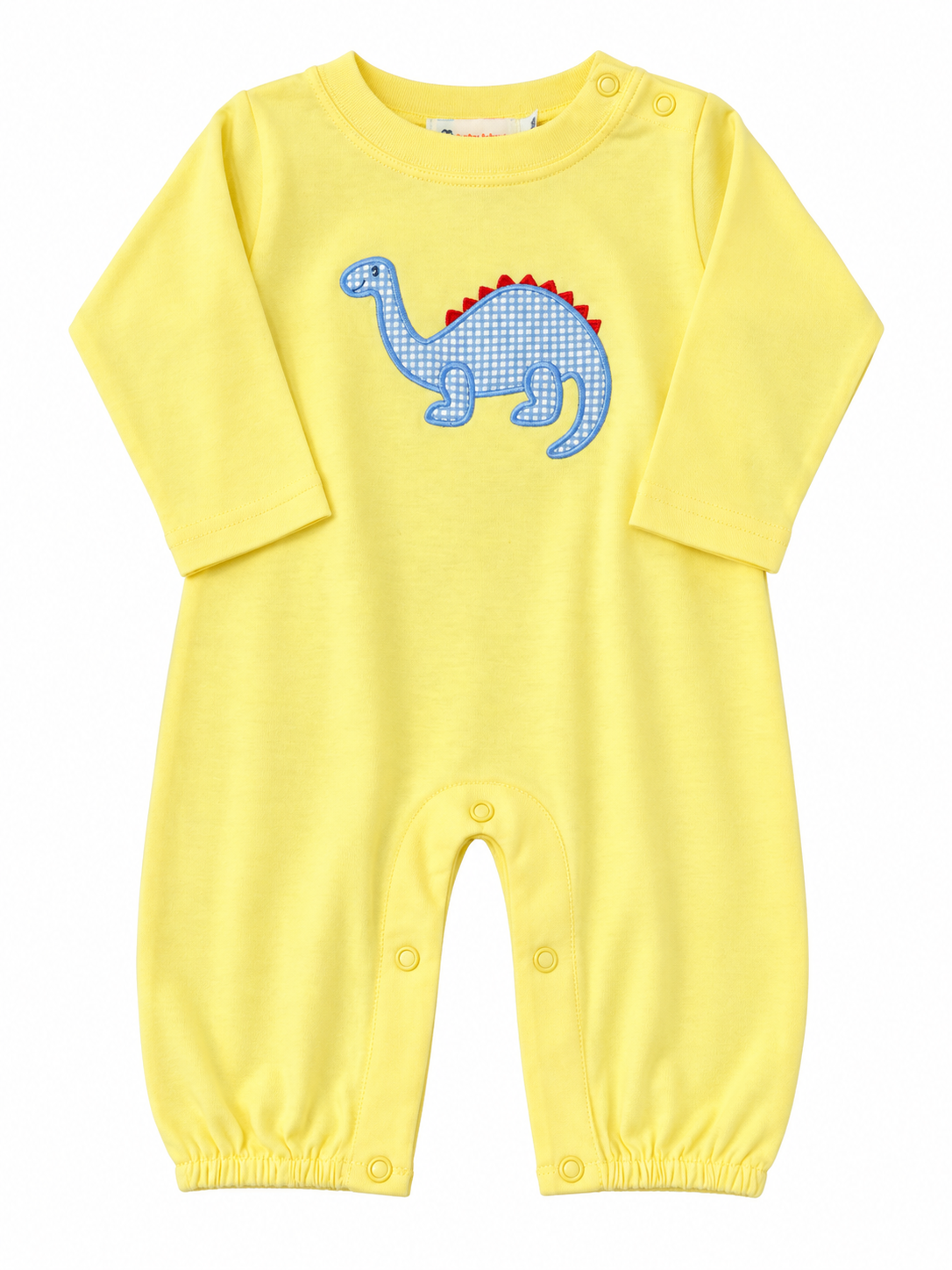 A baby long-sleeve romper in bright yellow, featuring a blue and white checkered dinosaur applique on the chest with red spikes, set against a plain white background.