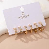 Set of gold hoop earrings with clear stones on a JOSSLYN Company card.
