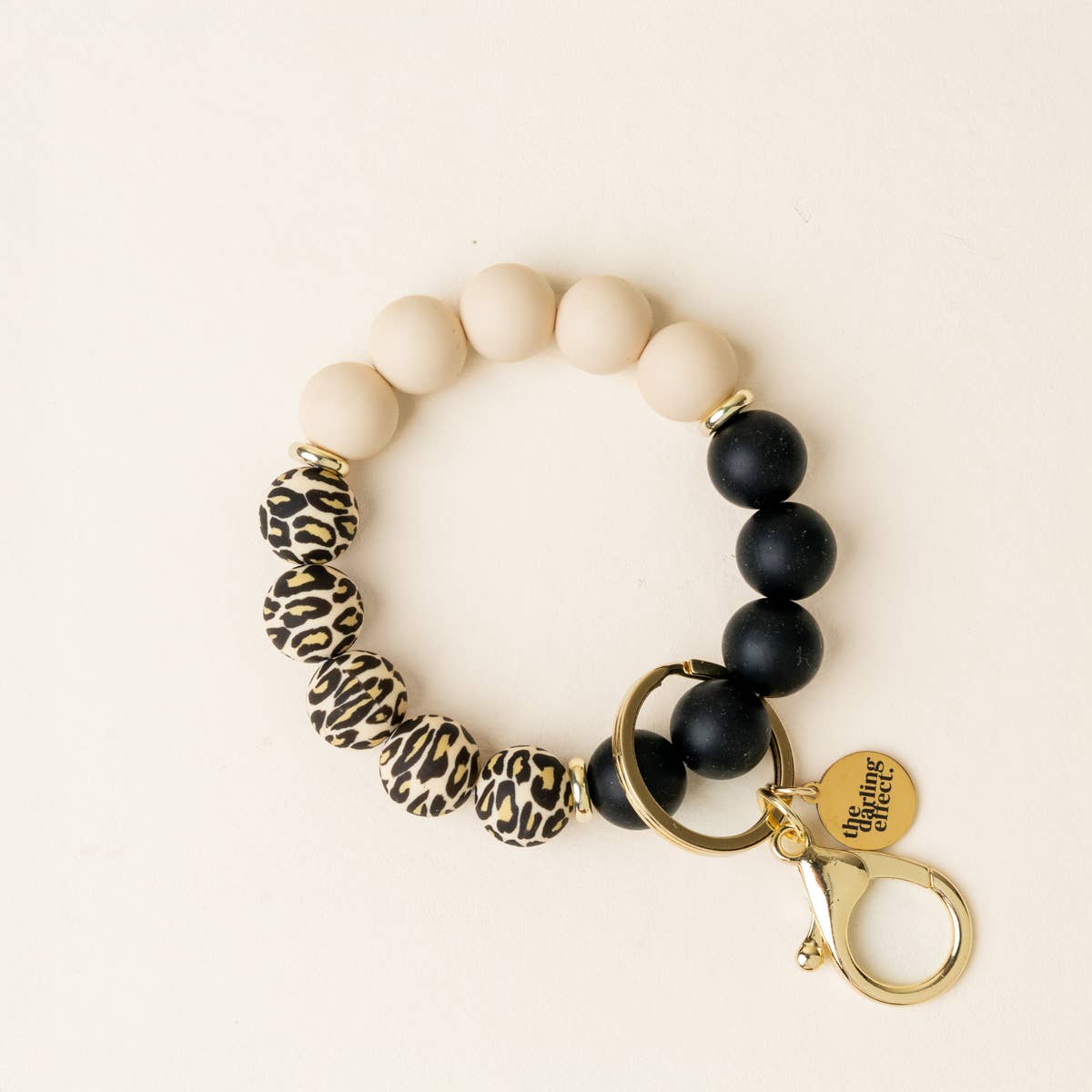 Bracelet with leopard print and black beads on a beige background