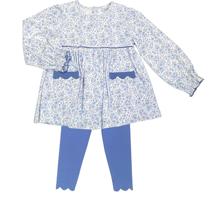 Children's outfit with floral top and blue pants on a white background