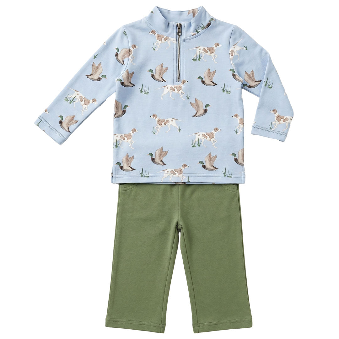 Children's outfit with a blue top and green pants featuring duck and dog pattern on a white background