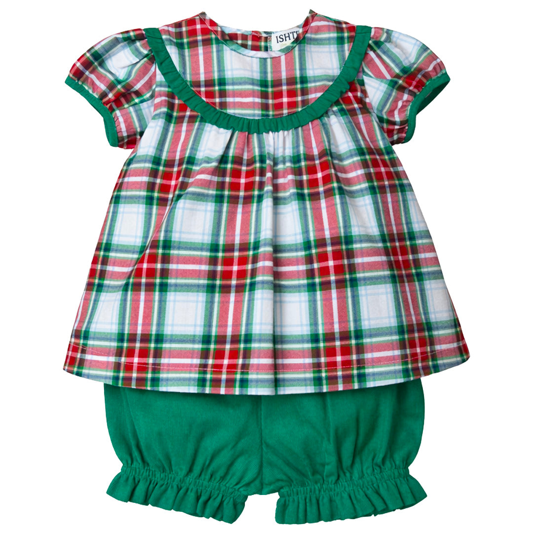 Children's outfit with plaid top and green shorts on a white background