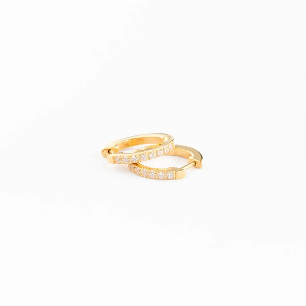 Gold ring with small diamonds on a white background