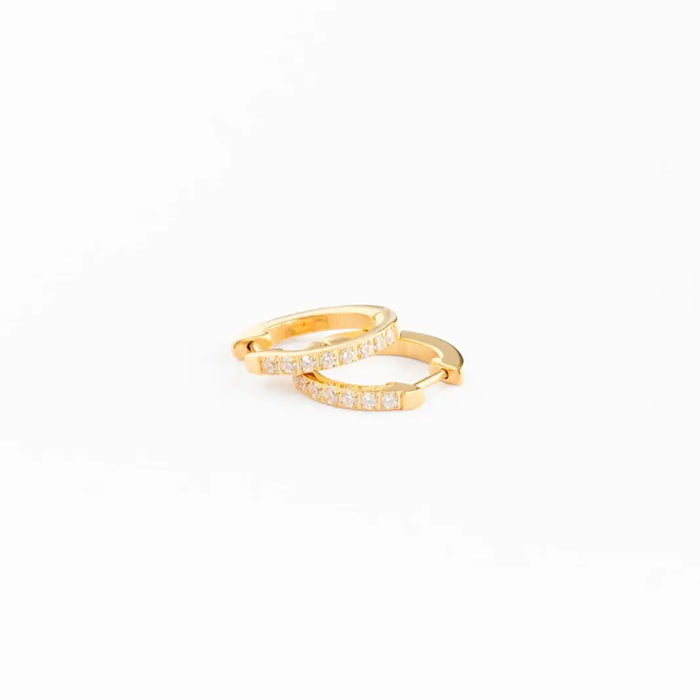 Gold ring with small diamonds on a white background
