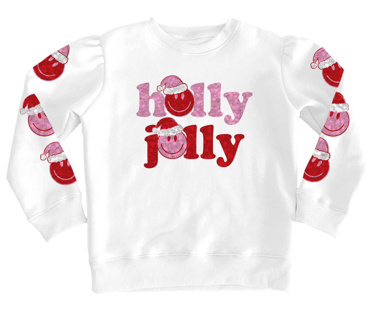 A white long-sleeve crewneck sweatshirt featuring 'holly jolly' printed on the front in pink and red glitter-textured lettering with Santa hats, and matching Santa graphics printed down both sleeves.
