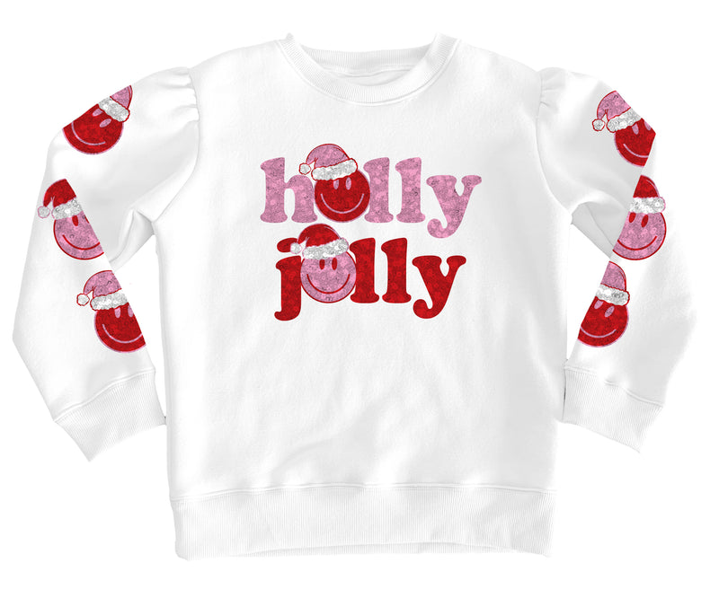 A white long-sleeve crewneck sweatshirt featuring 'holly jolly' printed on the front in pink and red glitter-textured lettering with Santa hats, and matching Santa graphics printed down both sleeves.