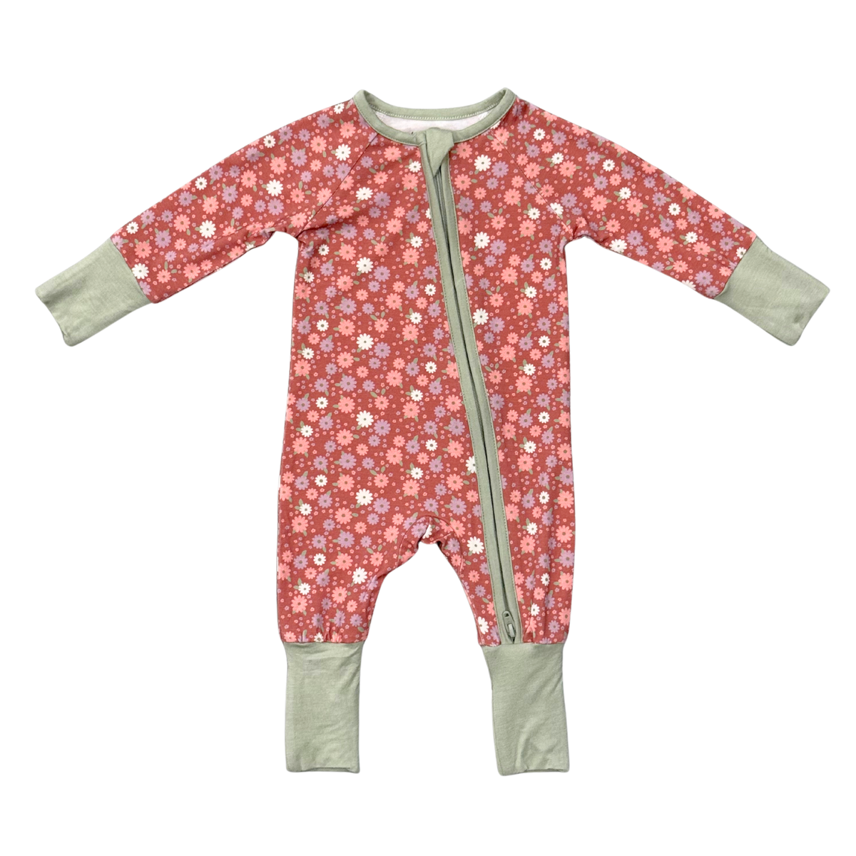 A baby long-sleeve footless sleeper with a pinkish-red background covered in a small white, purple, and yellow floral pattern, featuring sage green cuffs and a matching sage green front zipper.